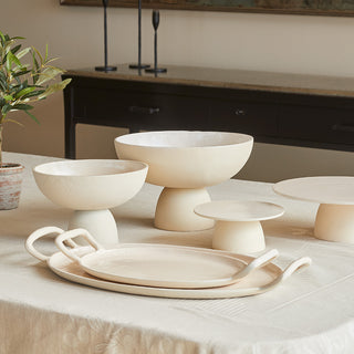 Artistic presentation of the Charlotte Serving Pedestal by CG Hunter, alongside various elegant bowls and trays on a beautifully set table.