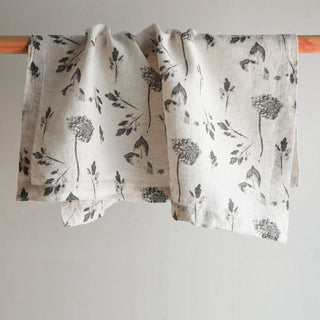 Gracefully draped floral tablecloth by CG Hunter featuring a refined grey hydrangea print, perfect for enhancing the dining experience.