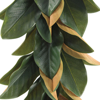 Close-up of a luxurious 9' Faux Green Magnolia Leaf Garland from CG Hunter, showcasing vibrant green leaves with realistic textures and warm undertones.