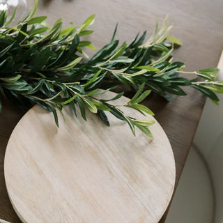 Green leaves on a wooden surface