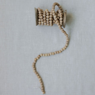 Natural Wood Handmade Bead Garland on Spool by CG Hunter, elegantly crafted beads showcasing exquisite craftsmanship, perfect for luxury holiday décor.