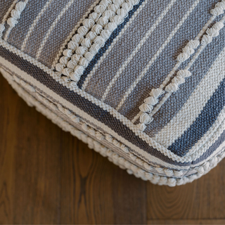 Close-up view of the Square Handwoven Stripe Loop Ottoman Pouf by CG Hunter, highlighting the intricate striped loop weave and plush design for a luxurious touch.