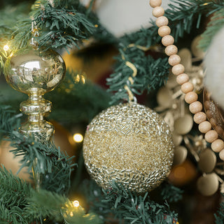 Elegant Shimmery, Round Jute Christmas Ornament by CG Hunter, featuring a glittering gold design, beautifully adorned on a holiday tree.