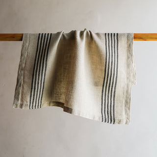 CG Hunter Striped Napkin in black and ivory hung elegantly, highlighting its luxurious texture and contemporary design, perfect for enhancing any table setting.