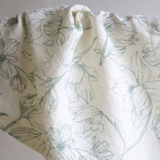 Detailed view of a CG Hunter Grey and Green Lilies Napkin featuring exquisite floral designs, ideal for sophisticated gatherings and luxurious dining occasions.