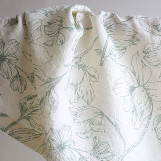 Close-up of CG Hunter Grey and Green Lilies Napkin displaying intricate floral patterns in soft green tones, perfect for adding a touch of luxury to your table decor.