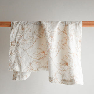 CG Hunter Handcrafted Linen Blush Lilies Napkins featuring an elegant floral design, showcased in a luxurious setting, enhancing upscale table decor.