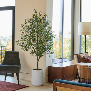 Sophisticated interior featuring the CG Hunter Artificial 7' Olive Tree in a stylish living room, complemented by modern decor and natural light, enhancing the Mediterranean ambiance.