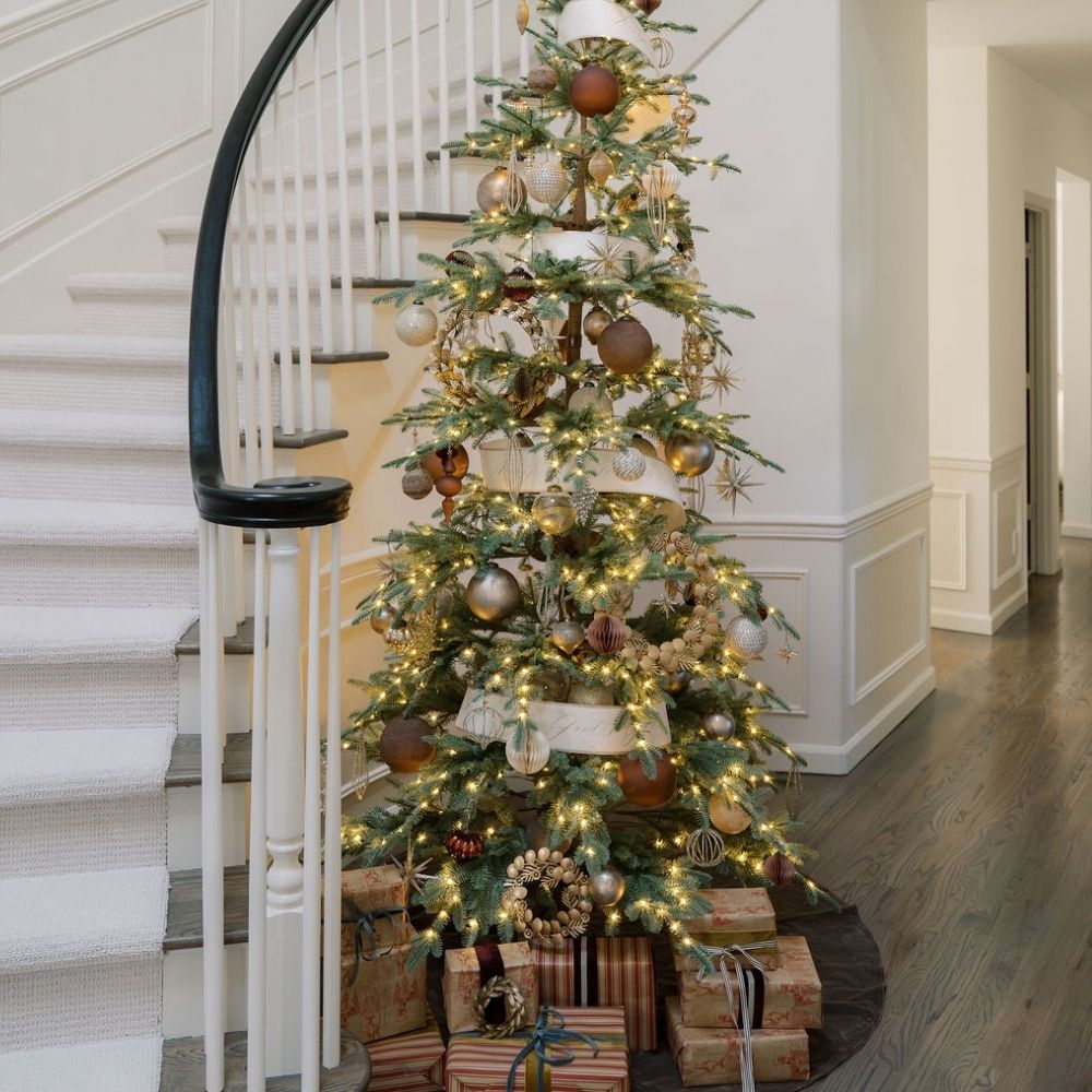 4" Champagne Assorted Ornament by CG Hunter, an exquisite holiday display featuring a lavishly decorated Christmas tree adorned with various ornaments.