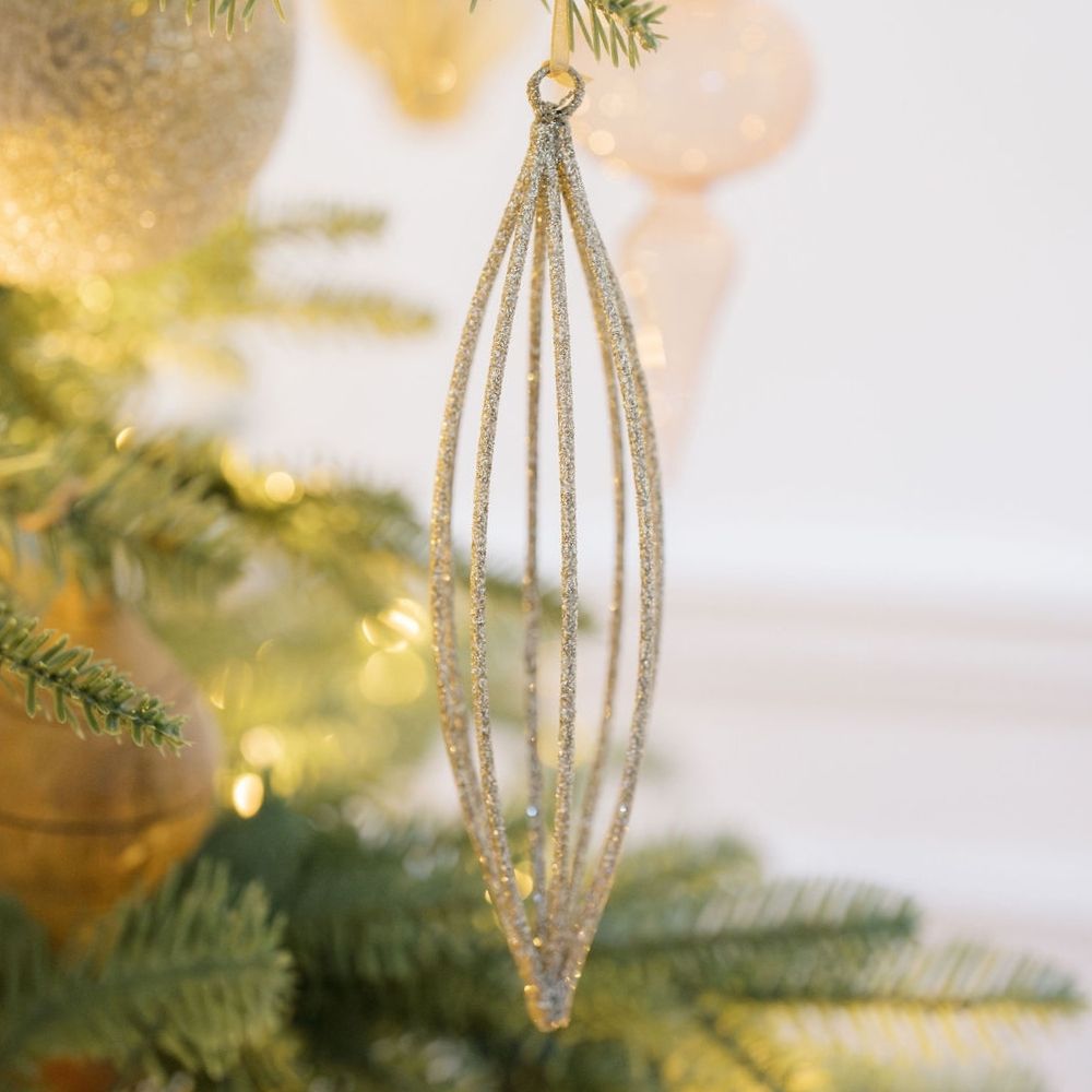Elegant 6.7" Champagne Assorted Ornament by CG Hunter, showcasing a shimmering, elongated design, perfect for enhancing holiday decor with a touch of luxury.