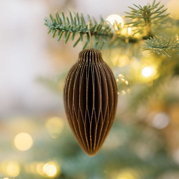 Luxurious CG Hunter 3" Paper Honeycomb Assorted Ornament in deep brown, elegantly hanging from a tree branch, showcasing its intricate folded design and warm seasonal tones.