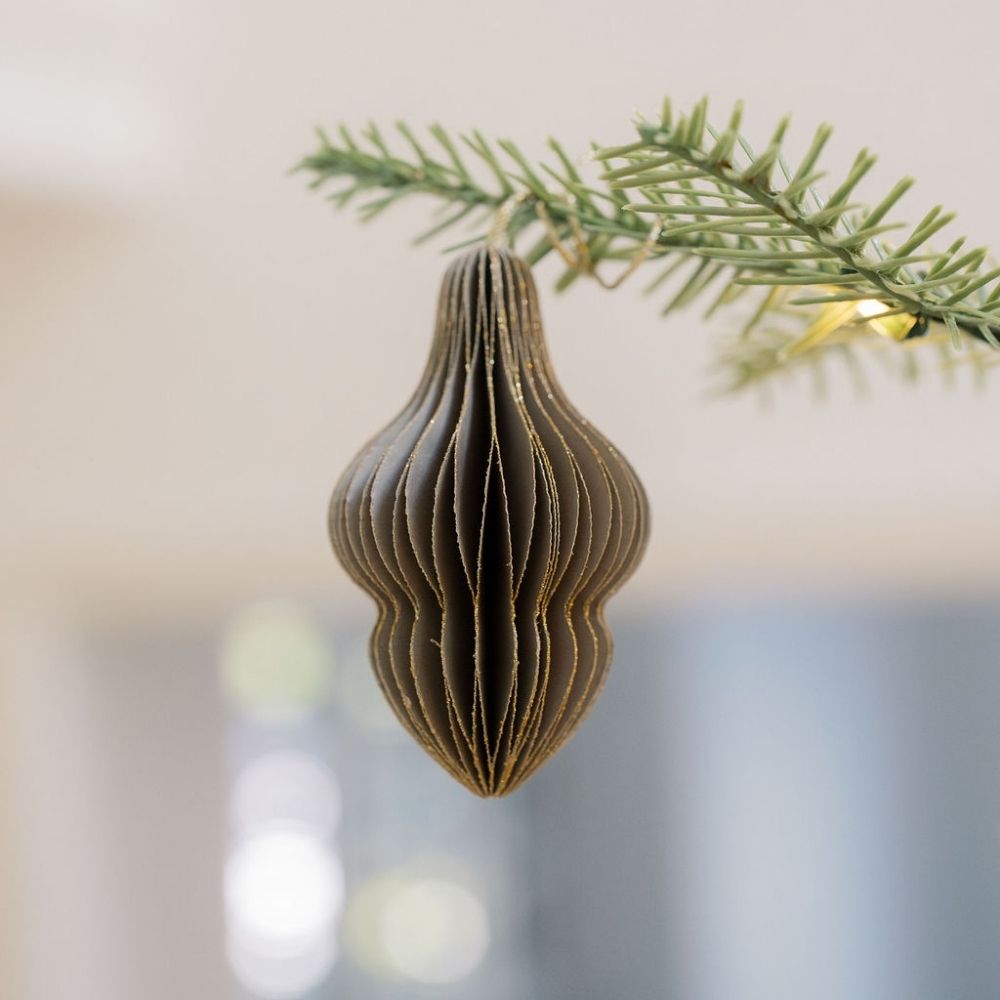 Chic CG Hunter 3" Paper Honeycomb Assorted Ornament in dark hues, gracefully hanging from a tree branch, featuring sophisticated honeycomb folds that add an artistic touch to holiday decor.