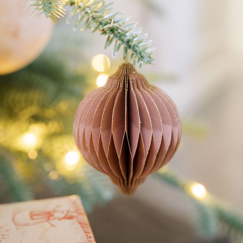 Delicate CG Hunter 3" Paper Honeycomb Assorted Ornament in soft blush tones, beautifully adorned on a tree branch, showcasing its intricate craftsmanship and enhancing seasonal elegance.