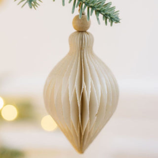 CG Hunter Crème Paper Honeycomb Assorted Ornament in a sculptural honeycomb design, elegantly adorning a Christmas tree with warm lighting, showcasing timeless holiday decor.