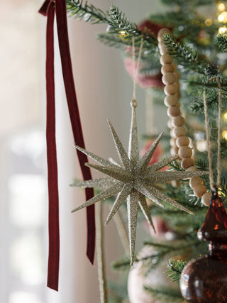 6" Starburst Gold Glitter Ornament on a timeless tree