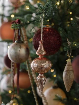 Glamorous copper glass finial ornament by CG Hunter nestled in a richly adorned Christmas tree, offering a luxurious addition to holiday decorations.