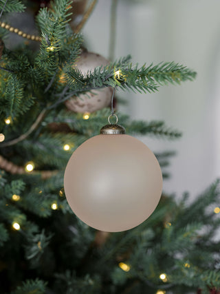 A beautifully crafted matte vintage rose glass ornament, measuring 4 inches, elegantly hanging on a Christmas tree, designed by CG Hunter for a sophisticated holiday touch.