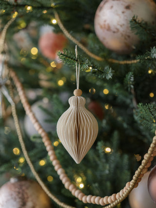 Luxurious paper ornament by CG Hunter, elegantly hanging on a decorated Christmas tree, showcasing a sophisticated design ideal for festive celebrations.