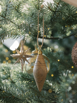 Chic Natural Mango Wood Ornament by CG Hunter displayed on a festive Christmas tree, featuring a unique shape and exquisite finish, perfect for holiday decor.
