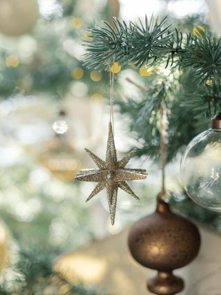 Another view of the exquisite Gold Glitter Starburst Ornament from CG Hunter, elegantly showcased within a lavishly decorated Christmas tree, capturing the essence of holiday luxury.