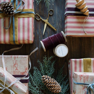 A stylish layout of festive gifts featuring various ribbons, including the Burgundy Wide Hand Dyed Velvet Ribbon from CG Hunter, highlighting elegance and seasonal flair.