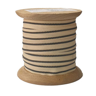 Grosgrain Ribbon in Cream and Black 10 Yards Per Spool by CG Hunter displayed on a handcrafted wooden spool, highlighting the ribbon's exquisite texture and elegant design.