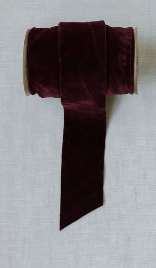 Rich burgundy hand-dyed velvet ribbon by CG Hunter, 10 yards per spool, offering a plush texture for luxurious gift wrapping and festive decorations.