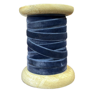 Chic Narrow Hand Dyed Velvet Ribbon in Deep Blue by CG Hunter, artistically coiled on a wooden spool, ideal for elevating your craft and decor projects with elegance.