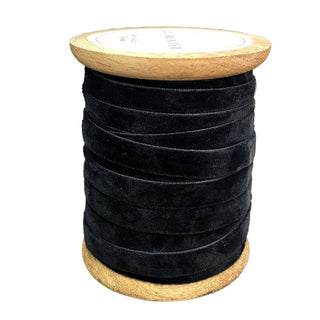 Narrow Hand Dyed Velvet Ribbon in rich dark blue by CG Hunter, beautifully arranged on a wooden spool, offering a luxurious touch to your home or holiday decor.