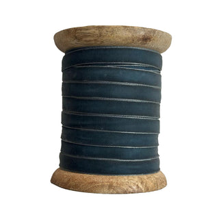 CG Hunter Narrow Hand Dyed Velvet Ribbon, beautifully arranged on a rustic wooden spool, featuring a rich dark hue that adds a touch of elegance to any creative project.
