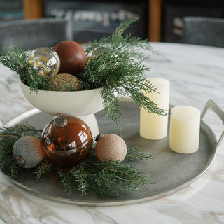 Luxurious decorative aluminum serving tray by CG Hunter, elegantly displaying festive ornaments and greenery on a marble surface, showcasing a stylish centerpiece.