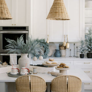 Elegant kitchen scene featuring the Charlotte Wood Serving Pedestal by CG Hunter, with a modern design, adorned tables, and delicate decor creating a sophisticated ambiance for entertaining.