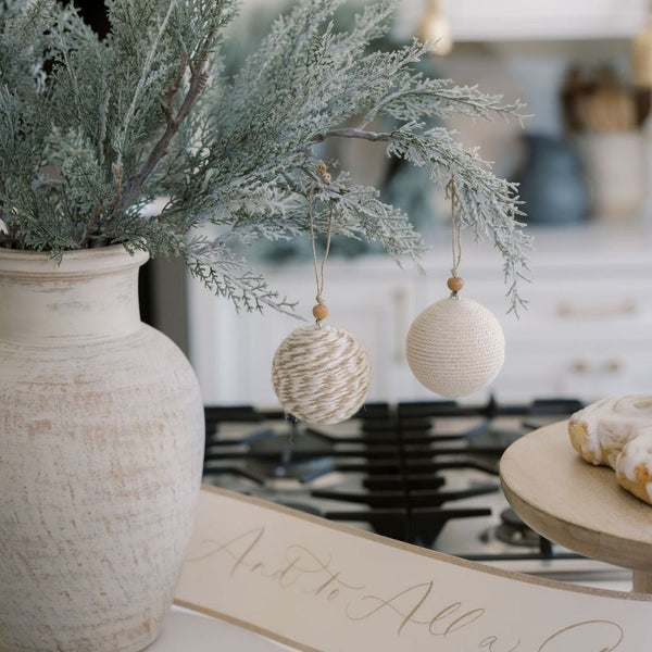 Close-up of the 27" Flocked Cedar Stem by CG Hunter, adorned with handcrafted ornaments, enhancing a stylish and festive kitchen decor.