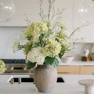 Vase with white flowers on a kitchen counter