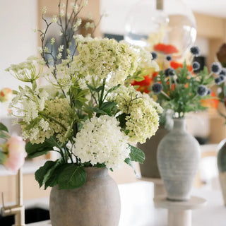 Bouquet of white flowers in a vase on a table with blurred background