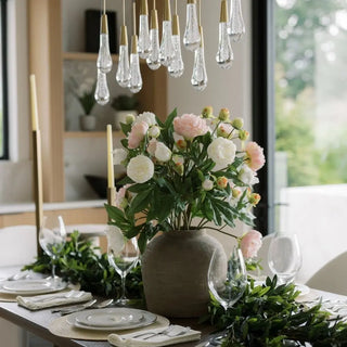 Decorative table setting with flowers and candles in a modern interior.