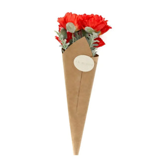 Bouquet of red flowers in a brown paper cone on a white background