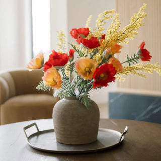 Decorative vase with flowers on a table in a home setting