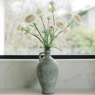 Vase with white flowers on a marble surface