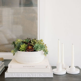Stunning 12" Faux Succulent Arrangement by CG Hunter displayed on a stylish stack of books, showcasing a modern white ceramic pot and vibrant greenery for luxury home decor.