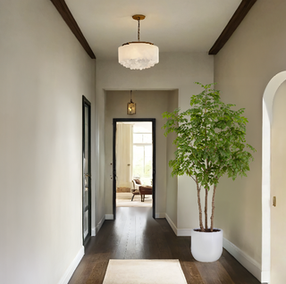Elegant hallway adorned with a CG Hunter 7' Faux Potted Sumac Tree, enhancing the stylish entryway with a touch of natural beauty.