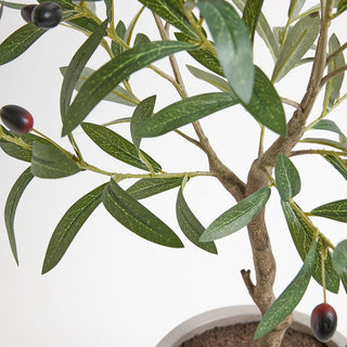 Close-up view of CG Hunter's faux Olive Topiary Tree, showcasing lifelike leaves and realistic black olives, perfect for luxurious interior design.