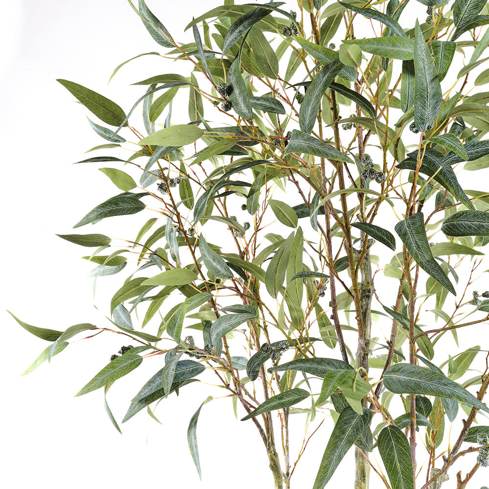 Close up on the silk lifelike leaves and handpainted tree branches of the  CG Hunter Artificial Willow Eucalyptus Tree 7' elegantly showcased in a bespoke Artisan Planter.