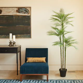 Stunning living room featuring the 7' Artificial Palm Tree by CG Hunter, elegantly positioned beside a stylish blue chair and modern artwork.