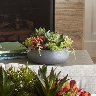 Sophisticated view of CG Hunter's round artificial succulent arrangement on a cozy living room table, merging elegance with the beauty of nature.