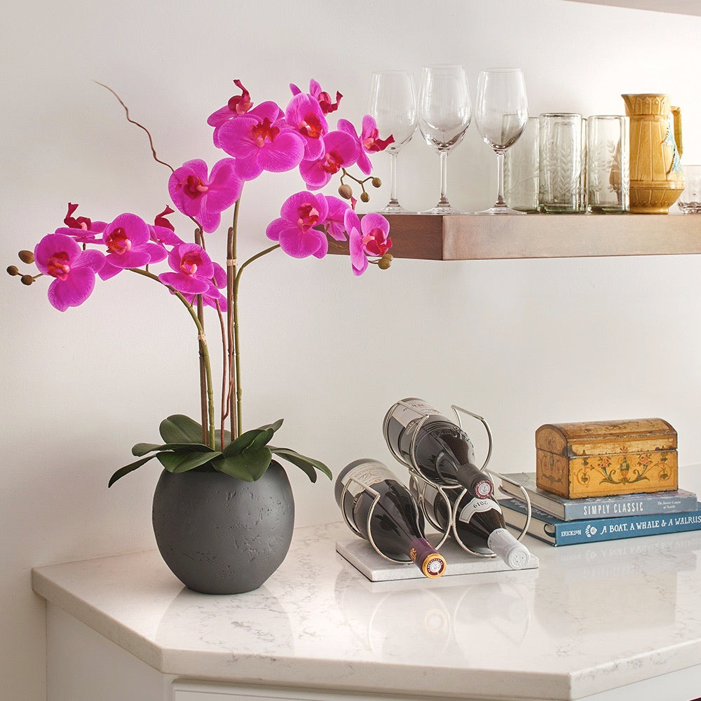 Faux Pink Double Stem Orchid in modern gray pot adds a touch of color to any room - seen here on a kitchen counter