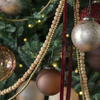 Chic Christmas tree decorated with hand-dyed velvet ribbons in rich hues, creating a luxurious holiday ambiance, by CG Hunter.