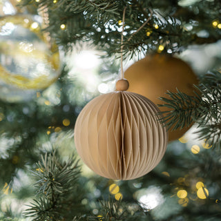 Stylish 4" Matte Antique Gold Glass Ornament by CG Hunter, featuring a unique textured design, elegantly hanging alongside complementary golden elements on a festive tree.