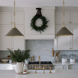 Luxury kitchen decorated with a 30-inch Faux Evergreen Cedar Wreath by CG Hunter, featuring elegant pendant lights and a sophisticated aesthetic.