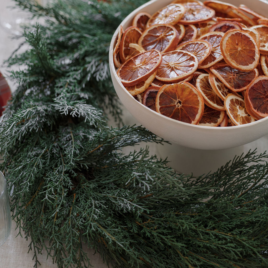 Close up of 30" Lifelike Cedar Wreath as centerpiece on table